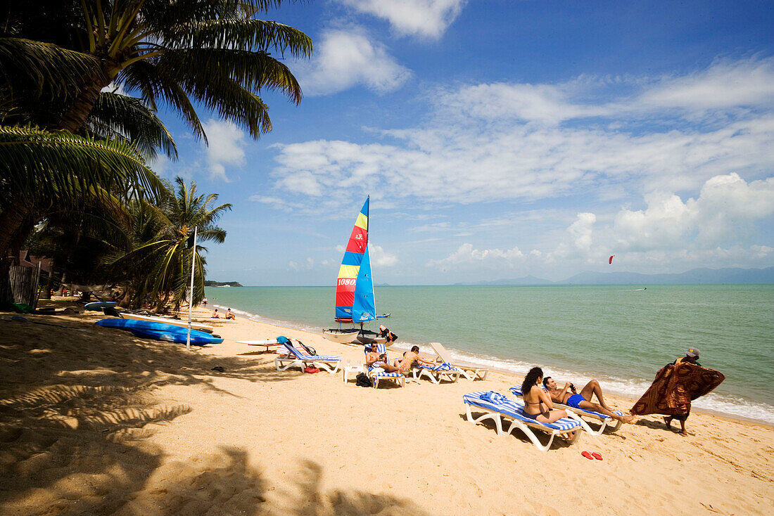 Vacationers sunbathing at Mae Nam Beach, Hat Mae Nam, Ko Samui, Thailand