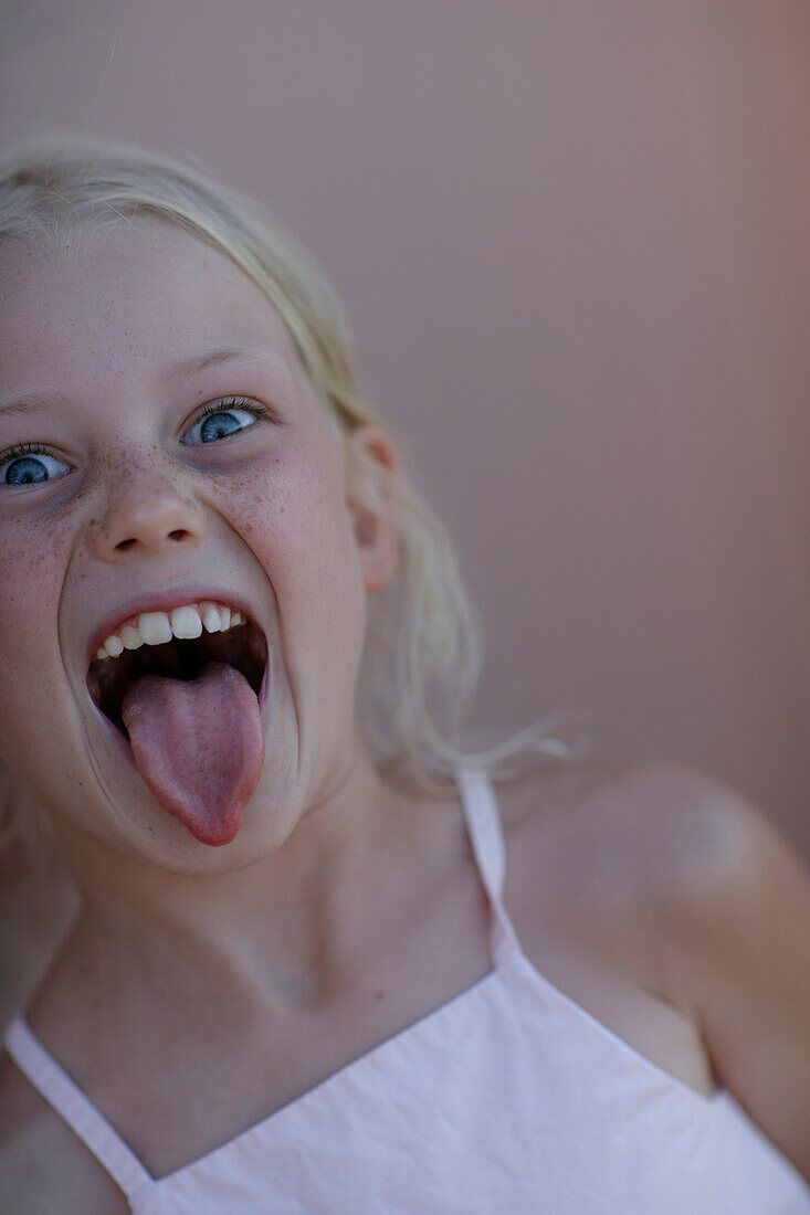 Girl sticking out tongue towards camera