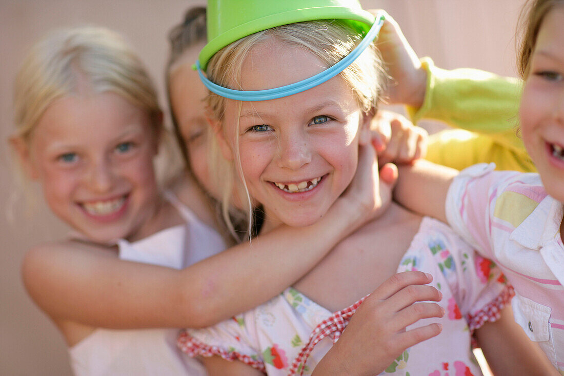 Girls  (5-8 years), one girl with bucket on head
