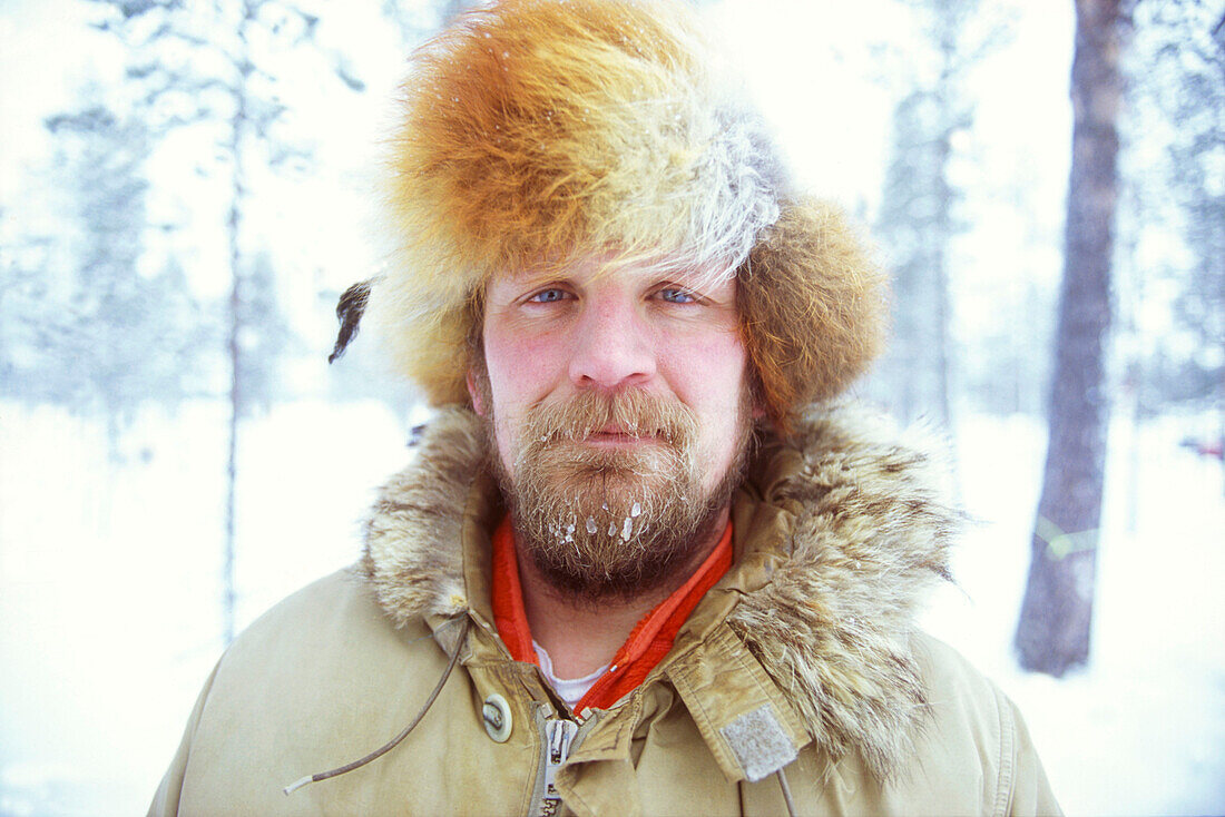 Portrait of a man with frozen beard in snowy forrest, Lappland, Sweden