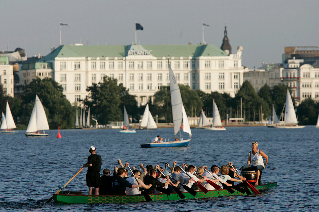 Big canoe on Inner Alster Lake, Atlantic Hotel in the background, Hamburg, Germany