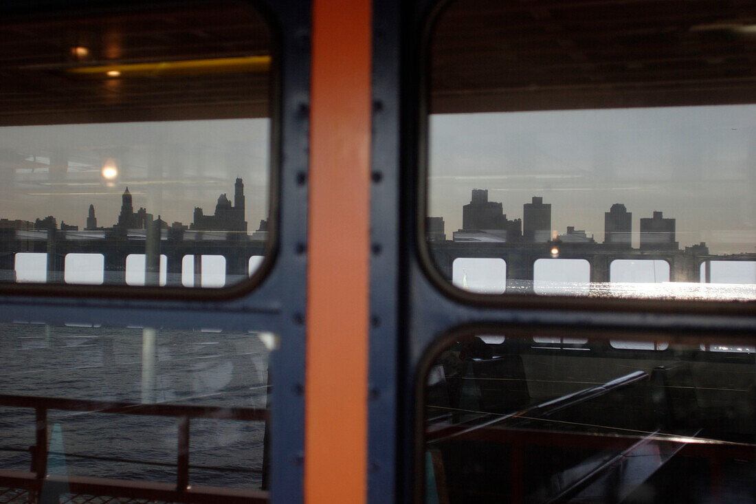 Windows of a ferry reflecting Manhattan's skyline, Manhattan, New York, America, USA