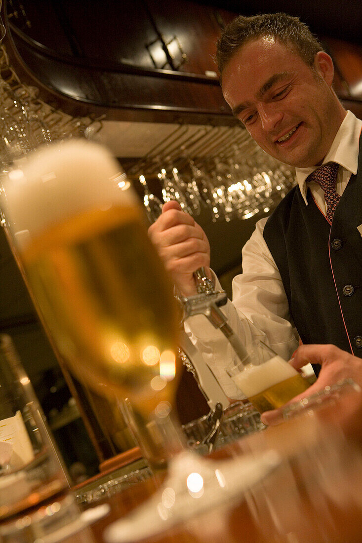 MS Bremen Barkeeper Radoslaw Pouring Beer in Bremen Club,Aboard MS Bremen Cruise Ship, Hapag-Lloyd Kreuzfahrten, Germany