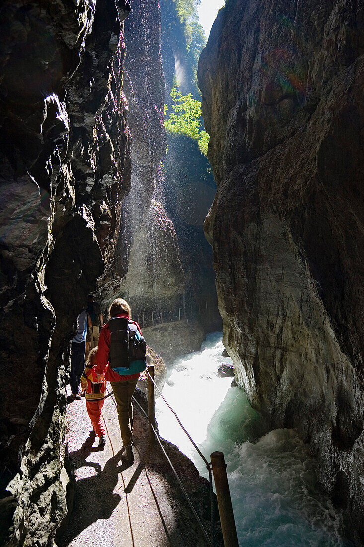 Family hiking in Partnachklamm gorge, Garmisch Partenkirchen, Upper Bavaria, Bavaria, Germany