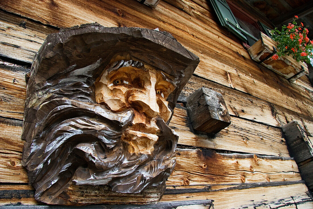 Woodcarving of a man on mountain hut, Krimmler Ache Valley, Hohe Tauern National Park, Austria