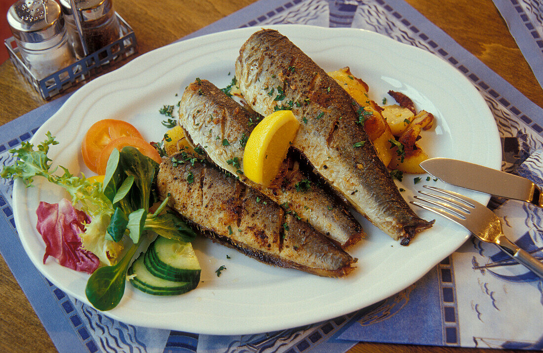 Fish speciality on a plate, Herring and roast potatoes, Rugen Island, Mecklenburg-Pomerania, Germany, Europe
