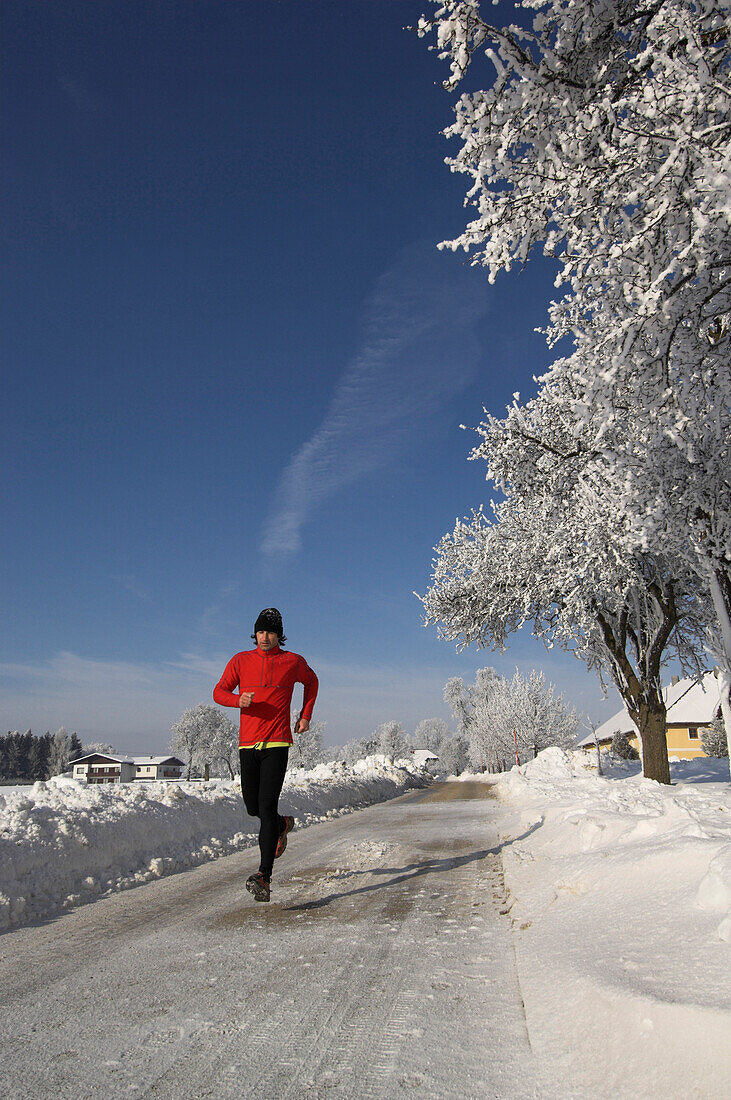 A man jogging in a winter landscape, Upper Austria, Austria