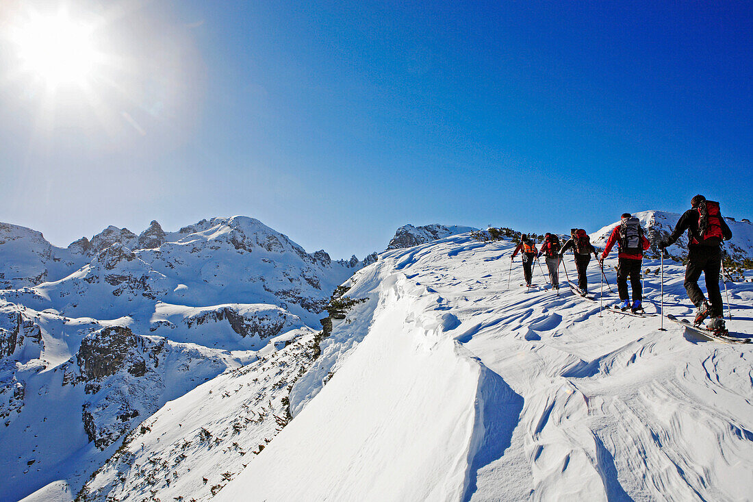 A group of people on a ski tour to the top of the Popova Kapa in the Rila Mountains, Europe, Bulgaria