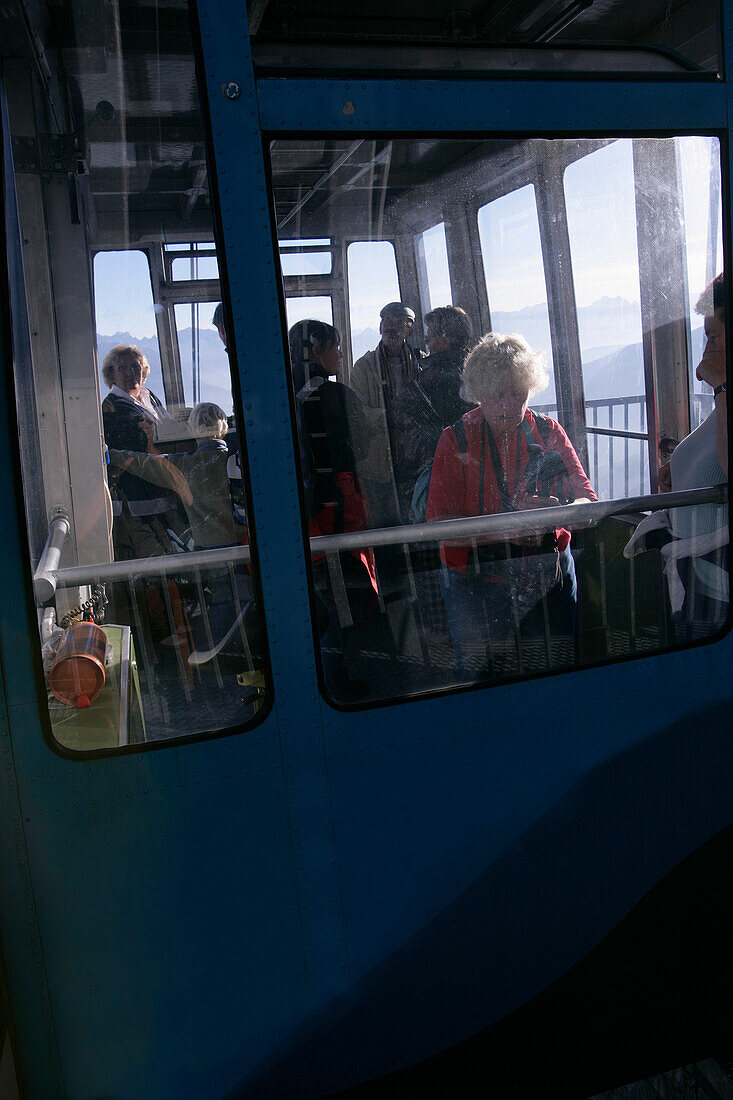 Hikers in the Herzogstand aerial tramway, Bavaria, Germany