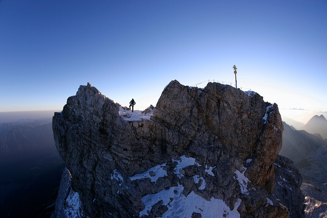 Man at the summit of the Zugspitze in the morning, Bavaria, Germany
