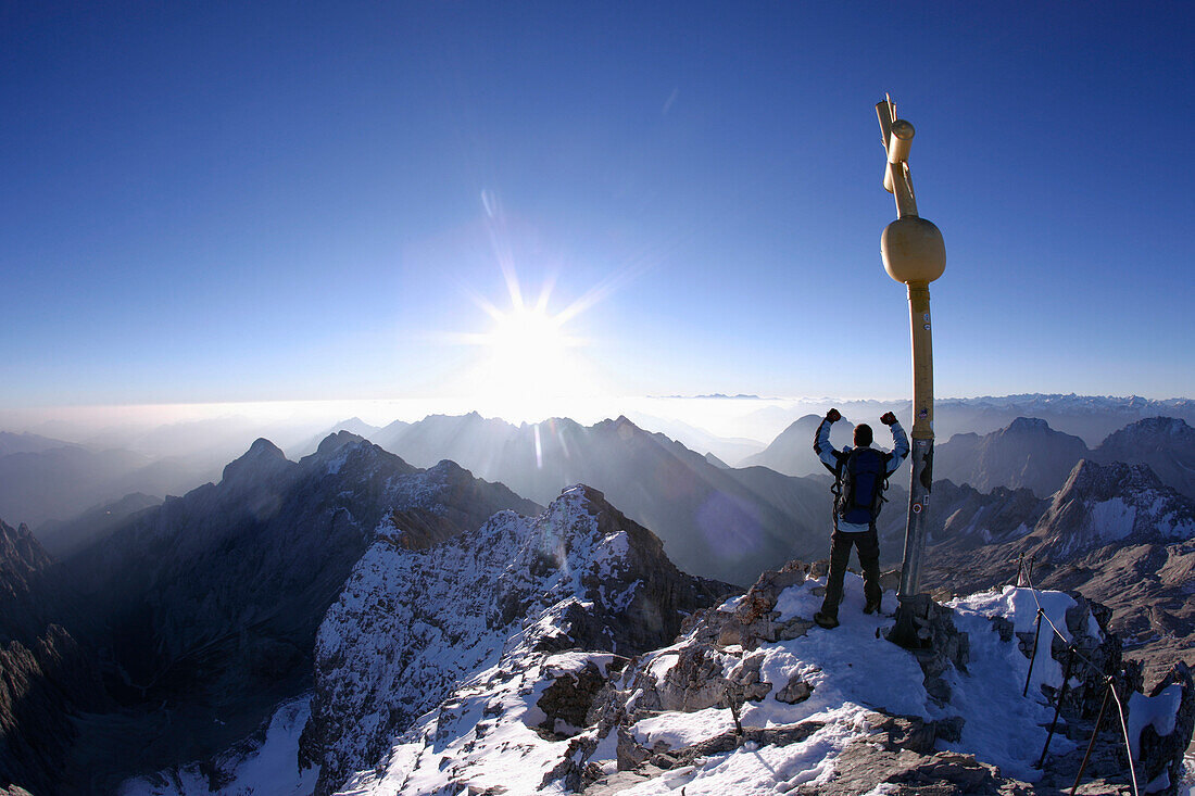 Man at the summit of the Zugspitze in the morning, Bavaria, Germany