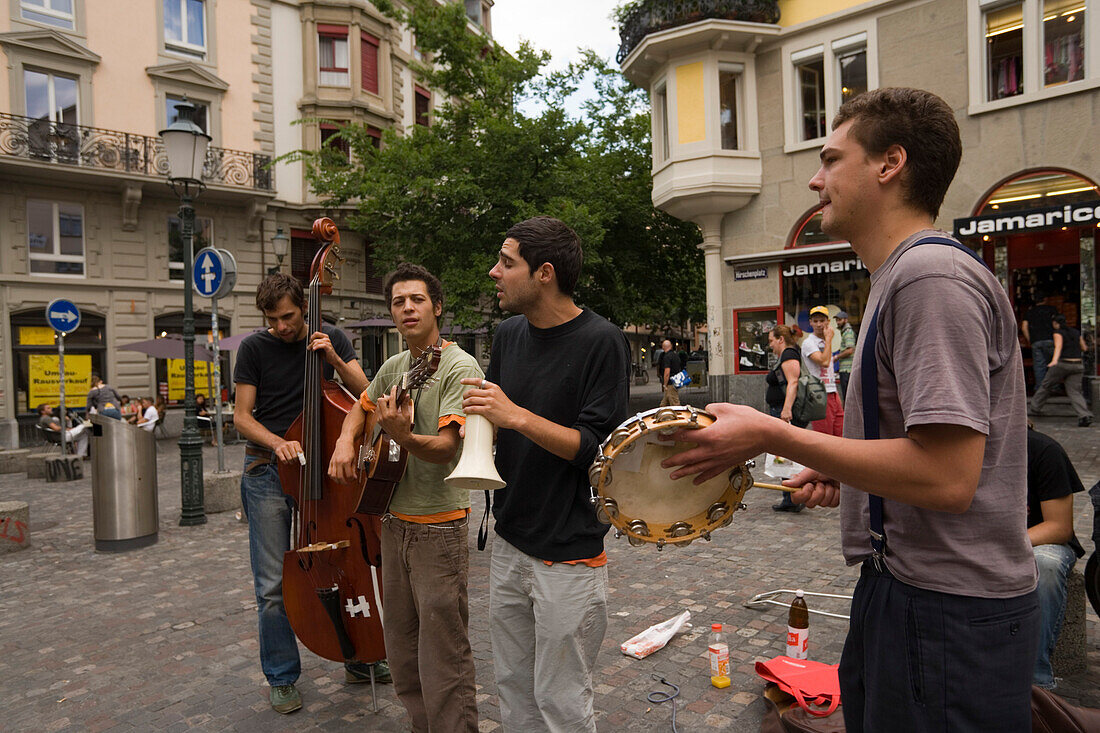 Group of young men making music on the Hirschenplatz, Niederdorfstrasse, Zurich, Canton Zurich, Switzerland