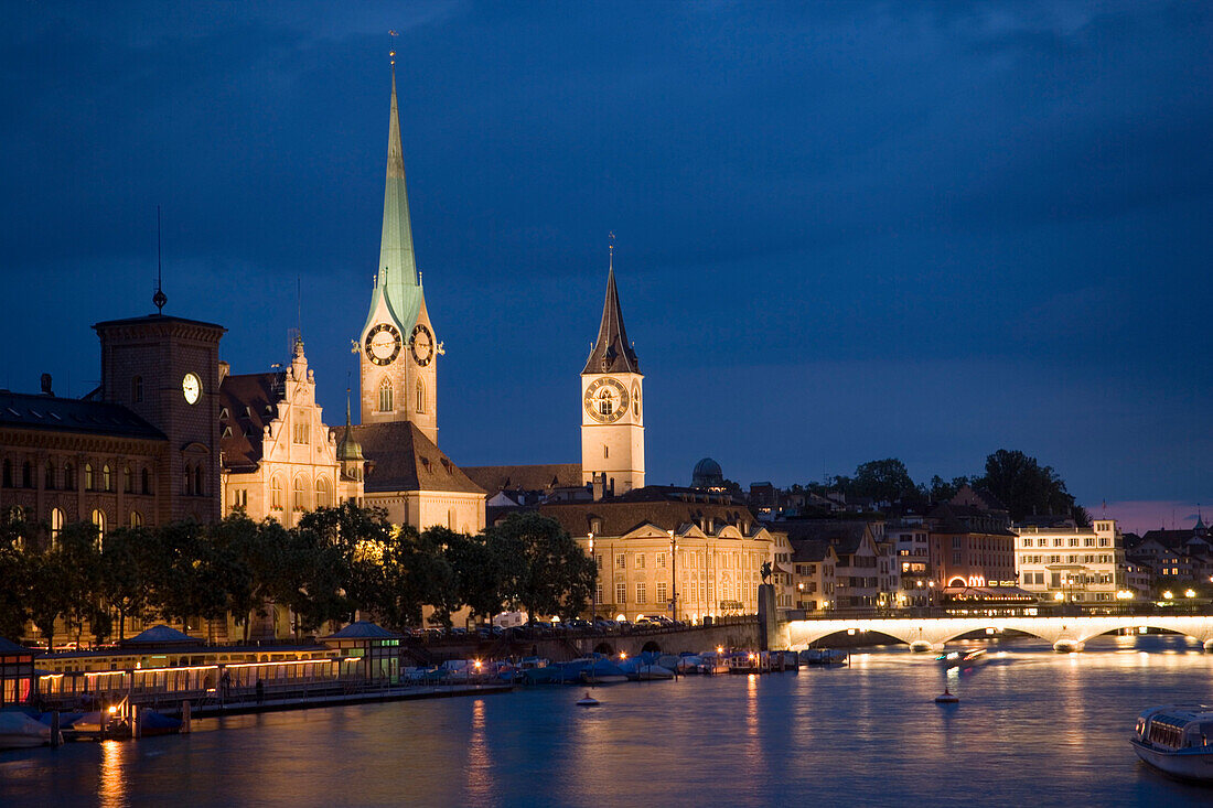 View over river Limmat to Fraumünster and St. Peter church at night, Zurich, Canton Zurich, Switzerland