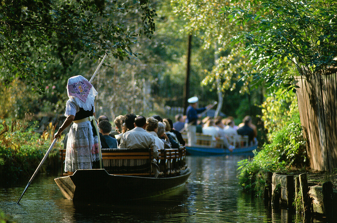 Tourists in rowing boats on river in Spreewald,  Brandenburg, Germany