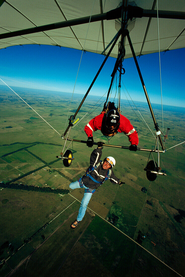 Man hanging below of a hang glider
