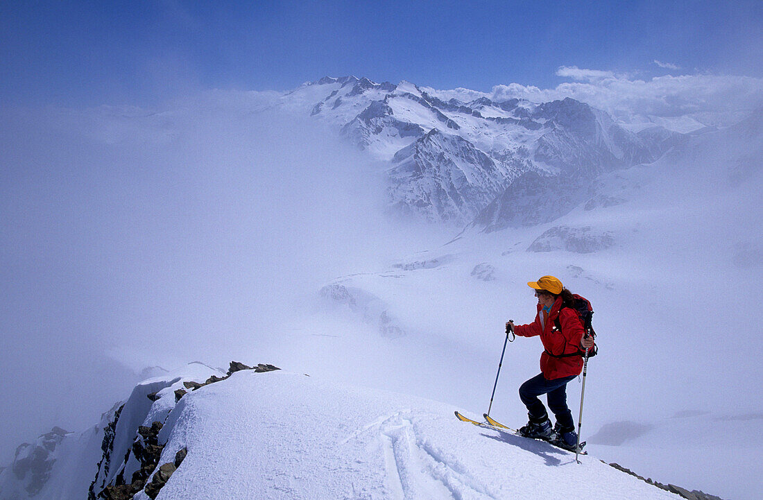 A person backcountry skiing at Sacroux in fog, Pyrenees, Spain