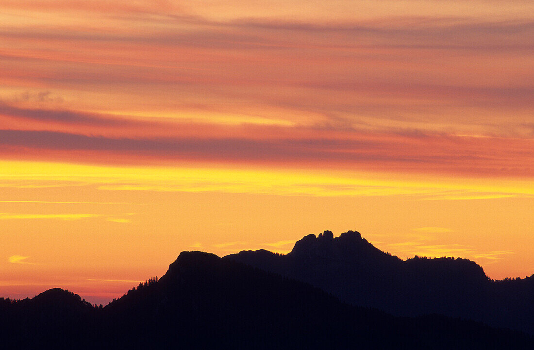Silhouette of Kampenwand in front of a glowing sky, Chiemgau, Upper Bavaria, Bavaria, Germany