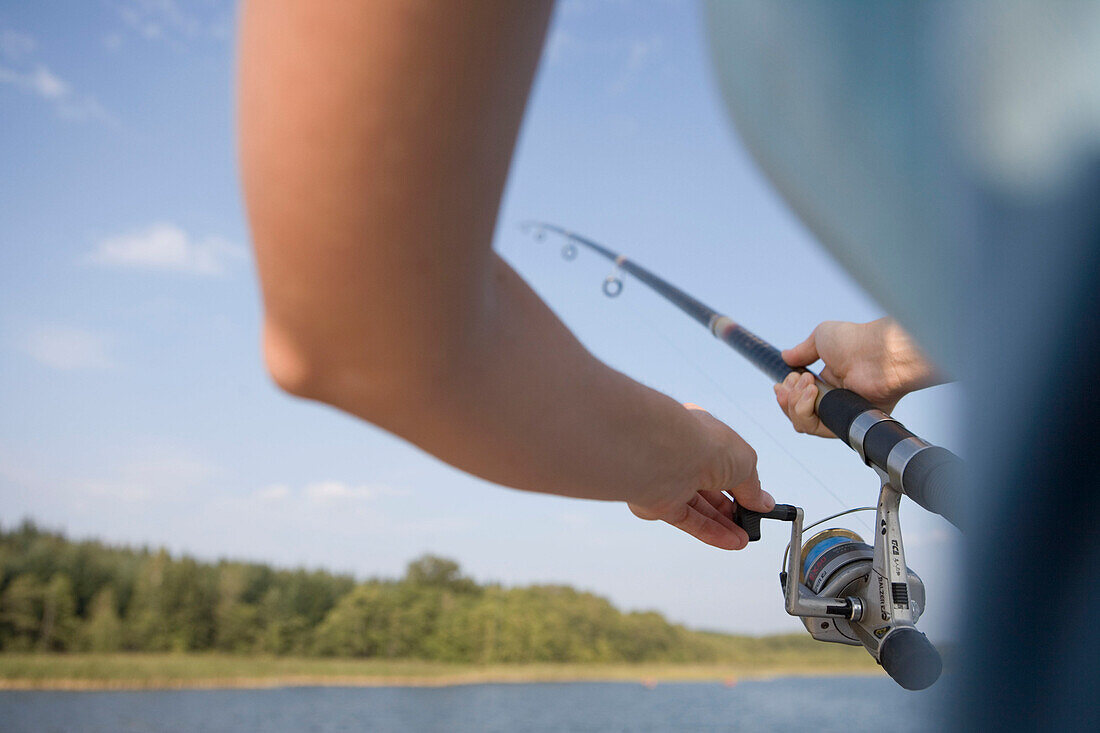 Woman with Fishing Rod, Crown Blue Line Classique Houseboat, Lake Labussee, Mecklenburg Lake District, Mecklenburg Western Pomerania, Germany