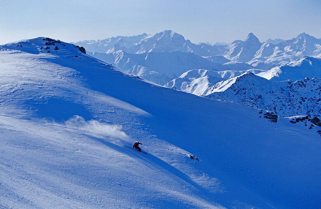 A young skier, a freerider skiing in powder snow at the Parsenn Skiarea, Davos, Klosters, Grisons, Graubuenden, Switzerland, Europe, Alps