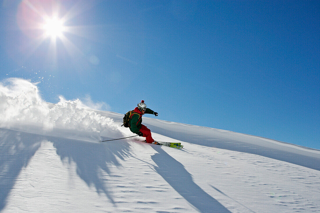 A young skier, a freerider making a turn in powder snow at Saentis, Appenzell, St. Gallen, Toggenburg, East Switzerland, Switzerland, Alps