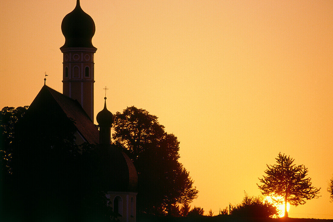 Silhouette of a church tower at sunset, Chiemgau, Lake Chiemsee, Bavaria, Germany, Europe