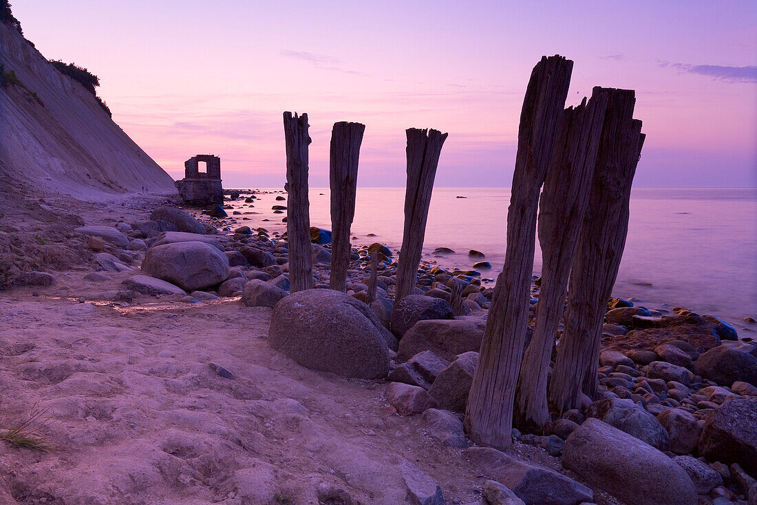 Wooden stakes on the beach at dusk, Cape of Arkona, Rugen Island, Mecklenburg Western Pommerania, Germany