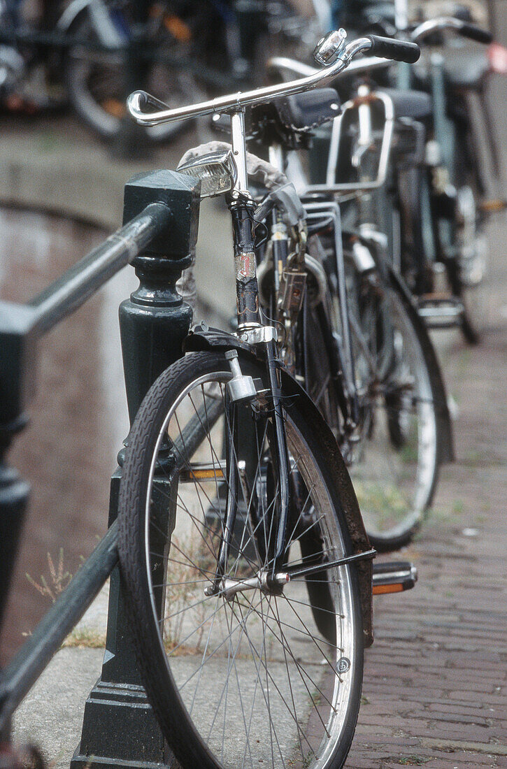 Bicycles chained up to a railing in Amsterdam, Netherlands