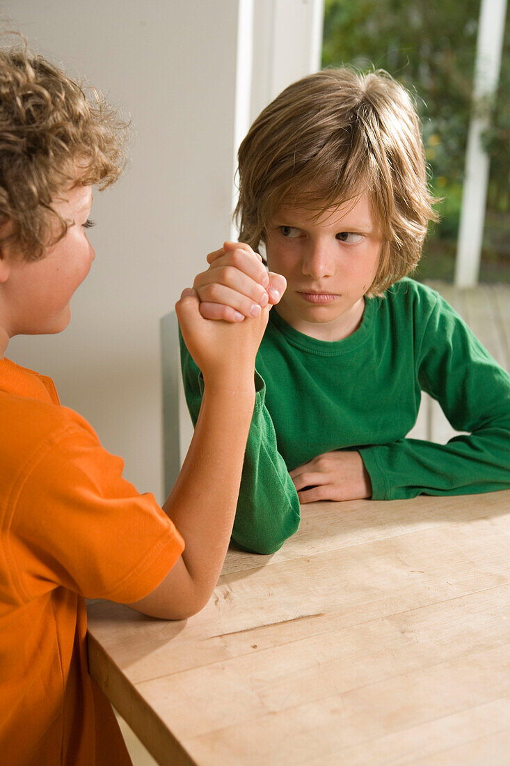 Two boys arm wrestling, children's birthday party