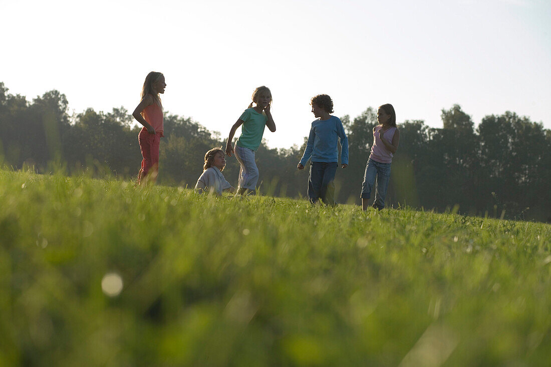 Children running over field, children's birthday party