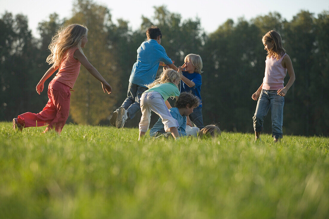 Children playing on grass, children's birthday party