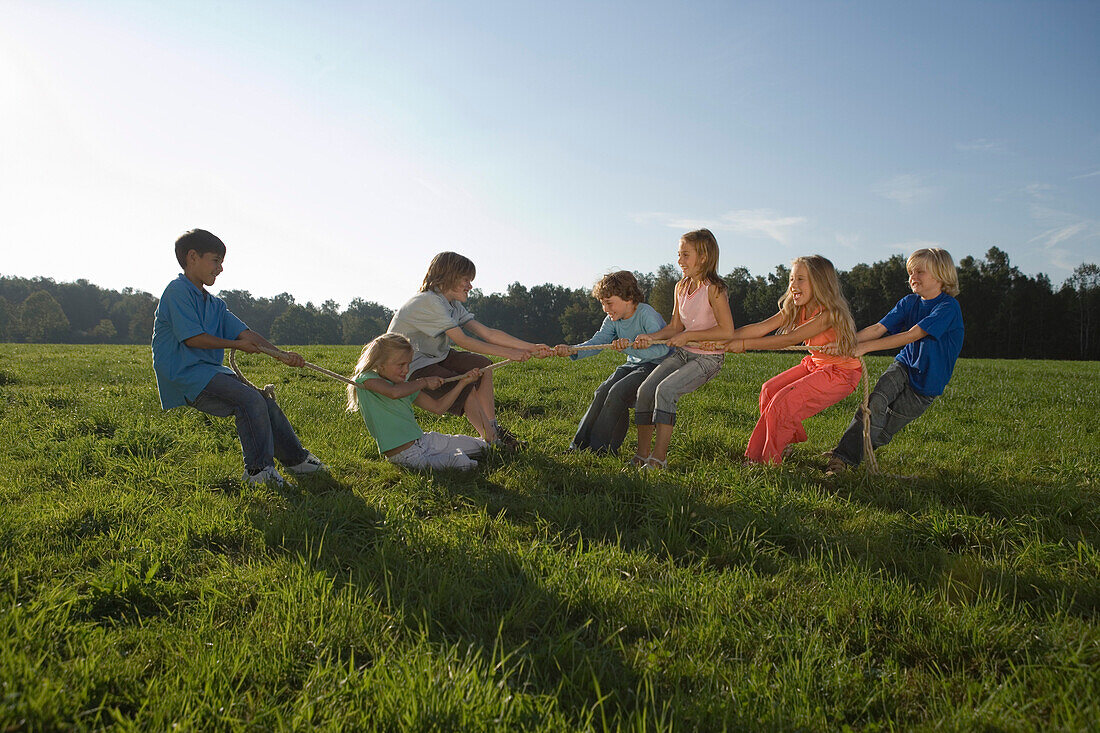 Children playing tug-of-war, children's birthday party