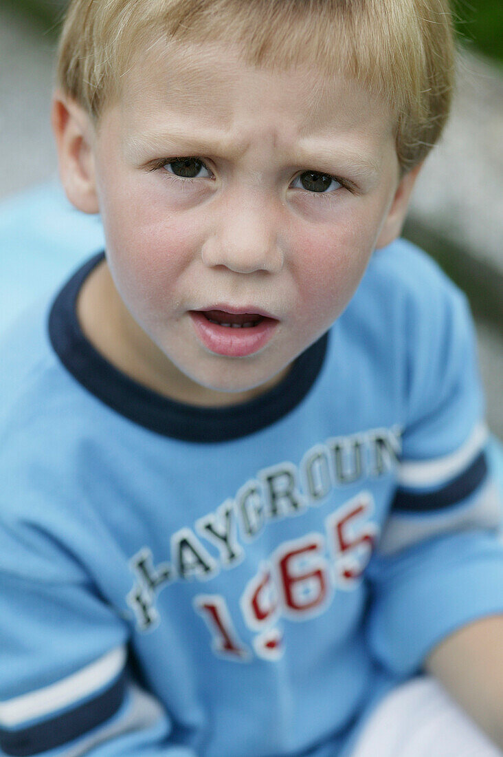 Young boy looking angry, Portrait