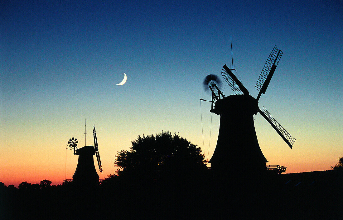 Twin windmills in sunset with moon, Greetsiel, East Friesland, Lower Saxony, Germany