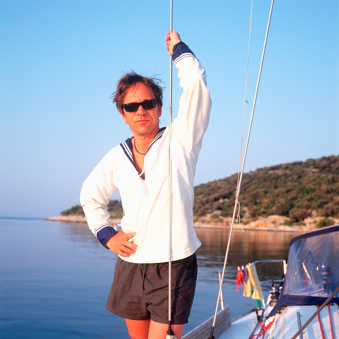 Man wearing sailor suit standing on sailboat, portrait, Adriatic Sea, Dalmatia, Croatia