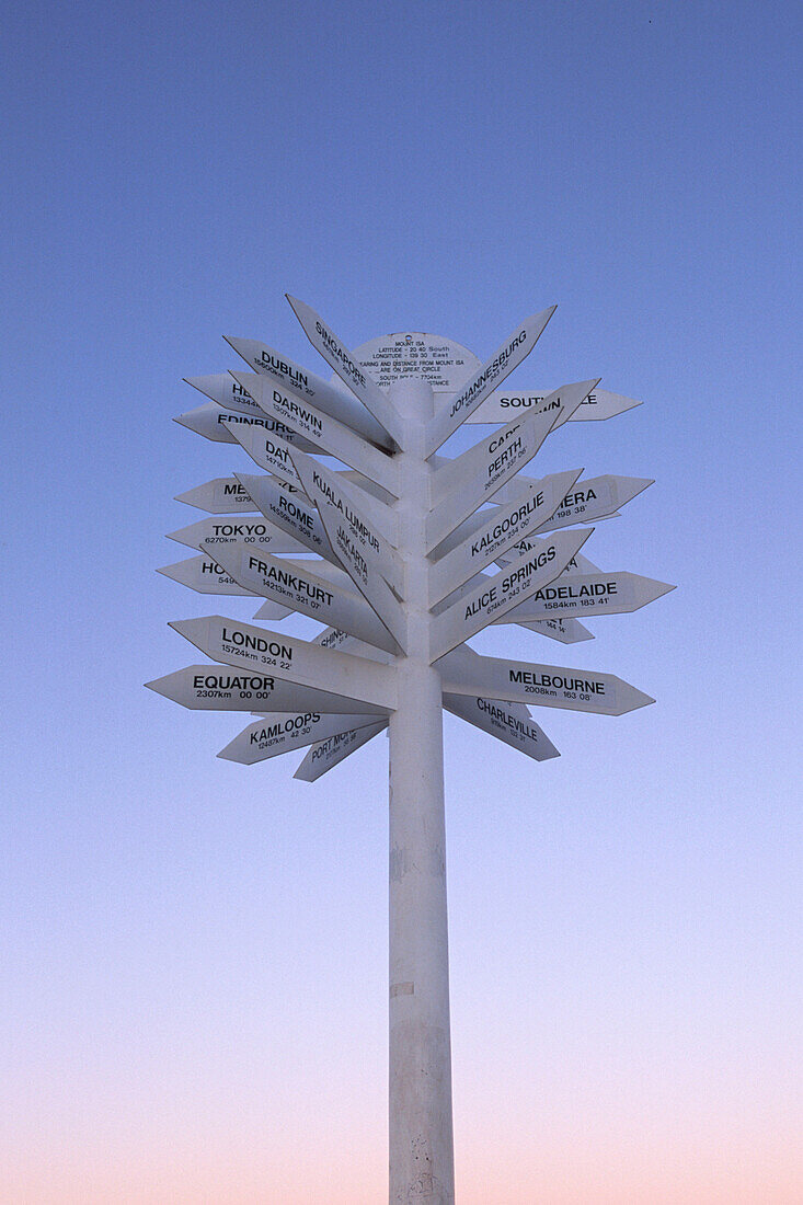 A distance signpost at Dusk, Mount Isa, Queensland, Australia