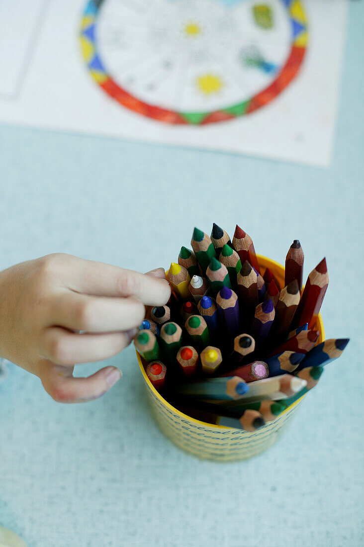Child choosing a crayon, close-up