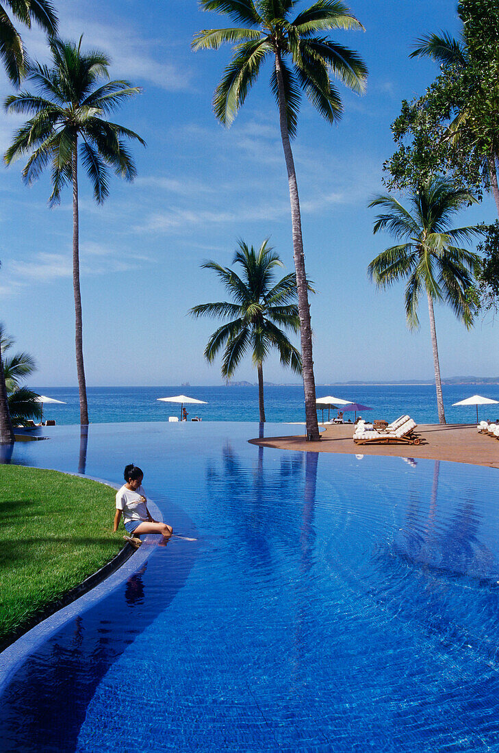 Woman sitting at the hotel pool, Hotel El Tamarino, Cihuatlan Jalisco, Mexico