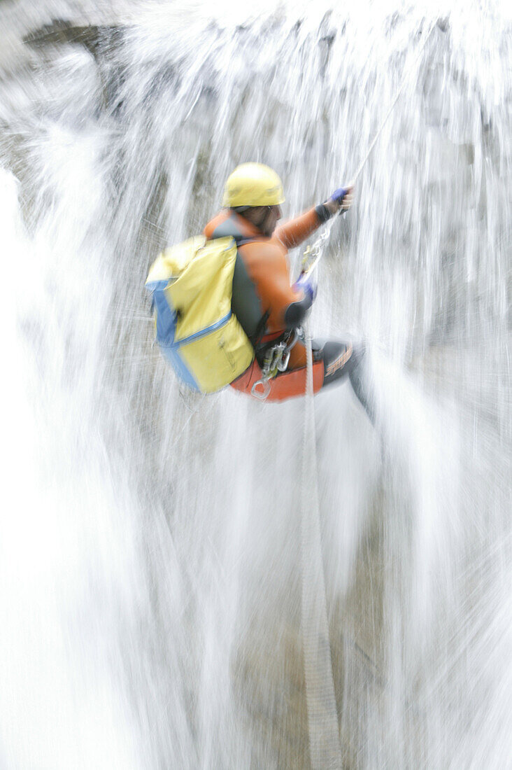 A man abseiling whilst canyoning, Hachleschlucht, Haiming, Tyrol, Austria