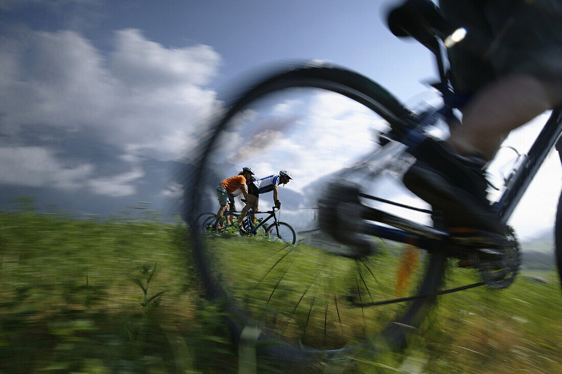 Cyclists riding mountain bicycles, Mieminger Plateau, Haiming, Tyrol, Austria