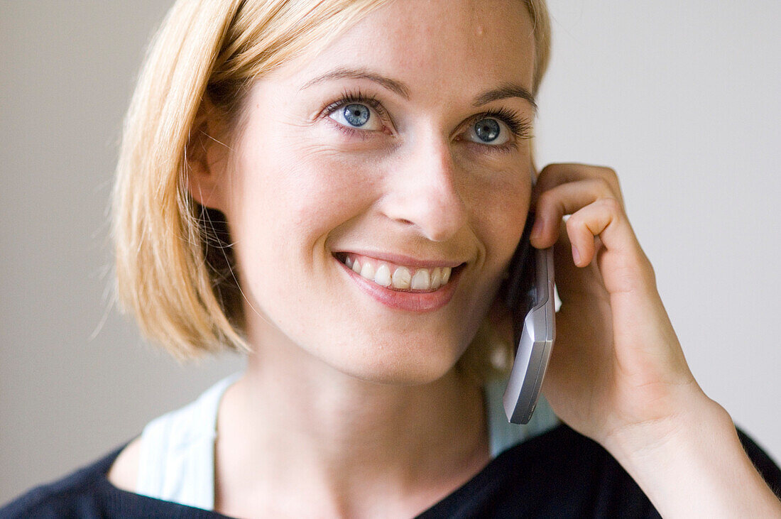 Young woman phoning with a mobile phone