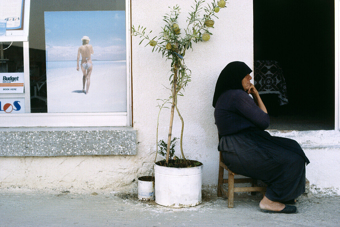A local woman sitting outside a house in Cyprus