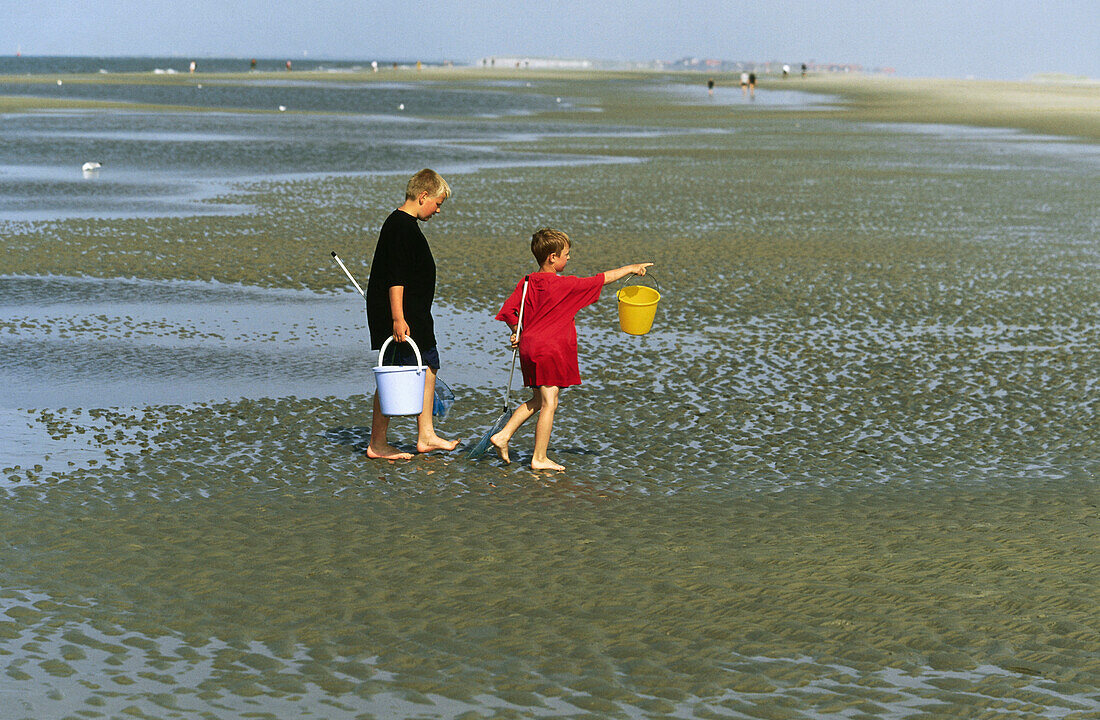 Children in mudflat, Norderney, East Frisia, Germany
