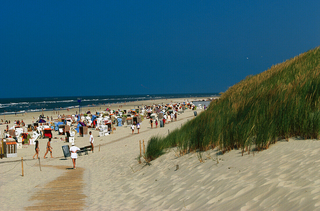 Urlauber am Strand mit Strandkörben, Spiekeroog, Ostfriesische Inseln, Niedersachsen, Deutschland
