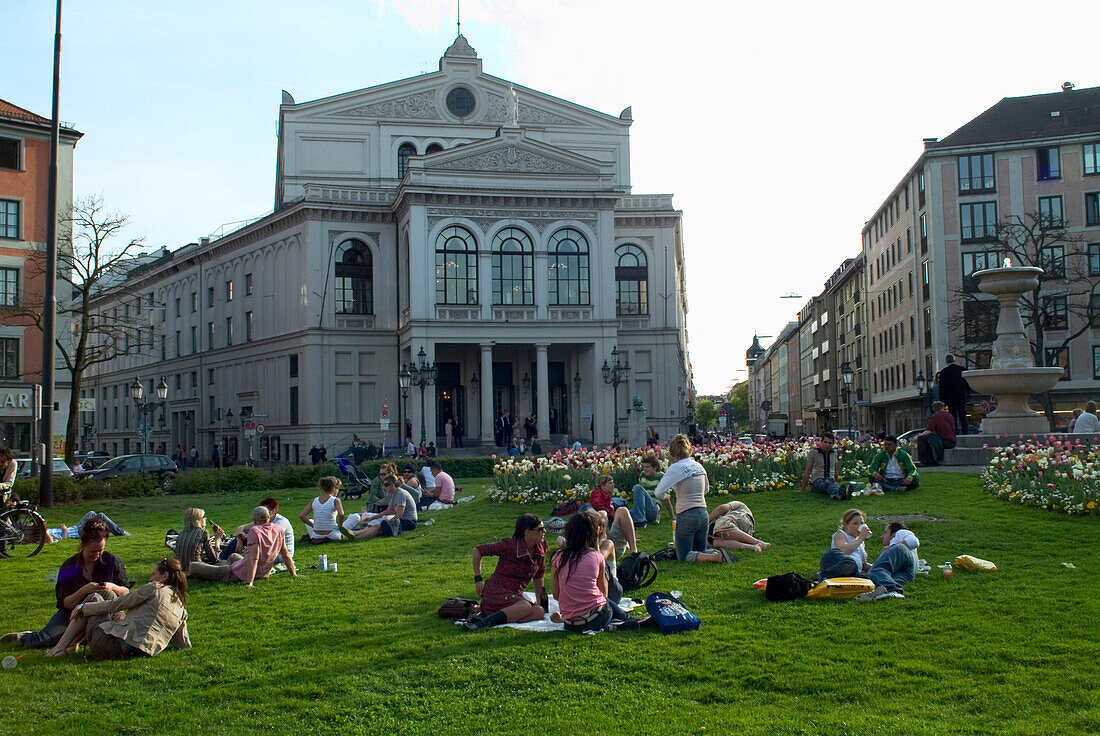 People sunbathing on Gaertnerplatz (square), Munich, Bavaria, Germany