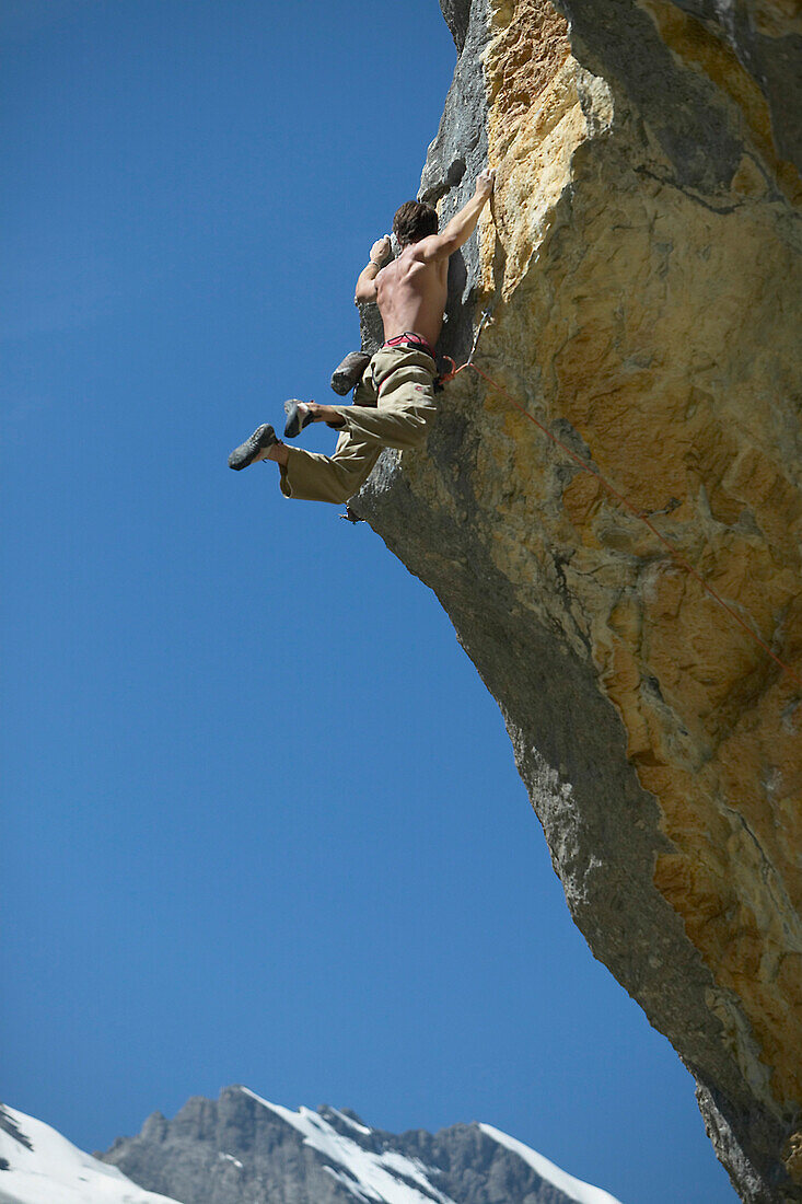 Free climber scaling rock face, Gimmelwald, Lauterbrunnen, Canton Bern, Switzerland