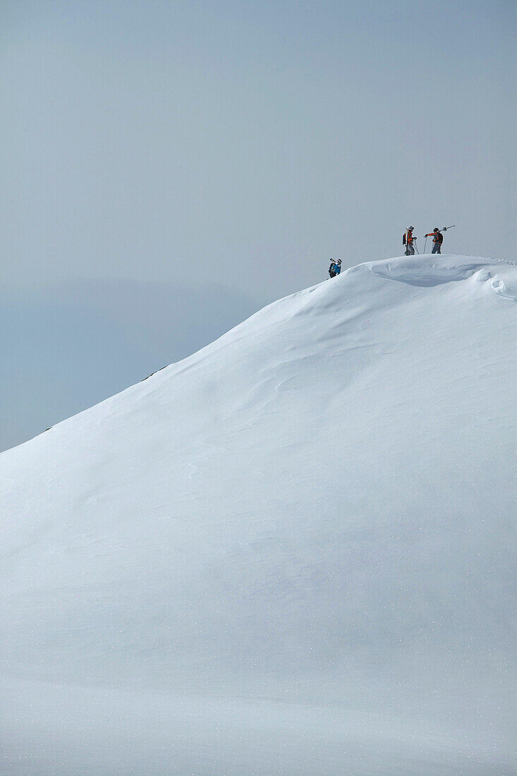 Three skiers on mountain, St Luc, Chandolin, Valais, Switzerland