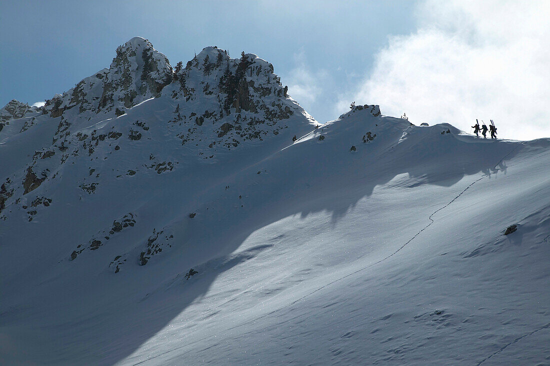 Hikers walking on ridge, St Luc, Chandolin, Valais, Switzerland