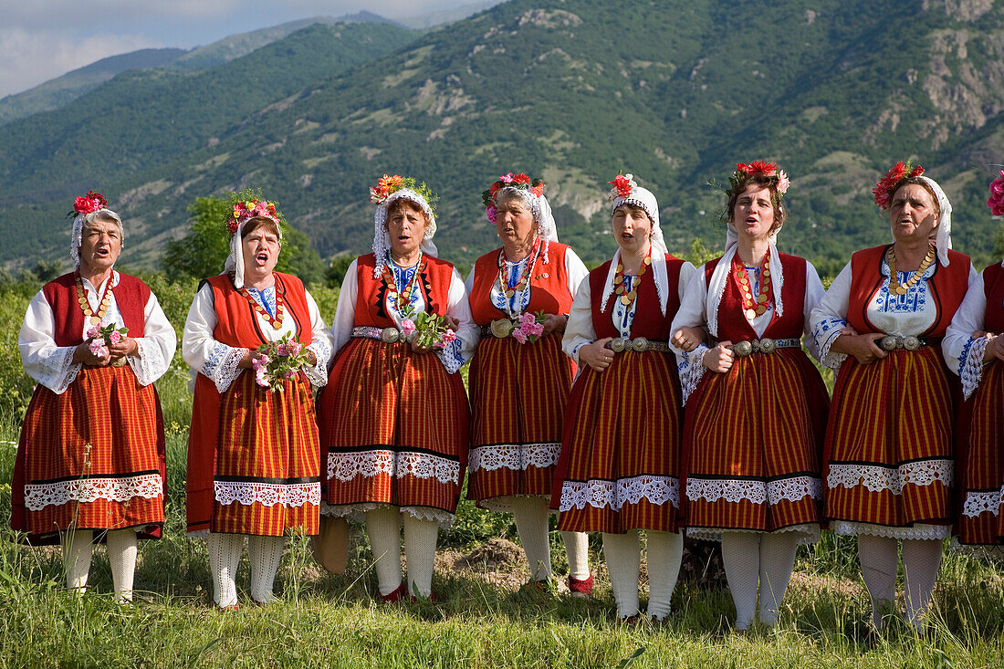 Singing women in traditional costumes at Rose Festival, Karlovo, Bulgaria, Europe