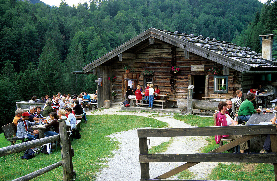 hikers having a break at alpine hut Harbachalm, Chiemgau, Upper Bavaria, Bavaria, Germany