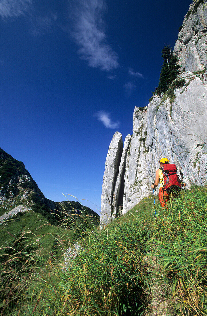 hiker beneath Plankenstein, Bavarian Alps, Upper Bavaria, Bavaria, Germany